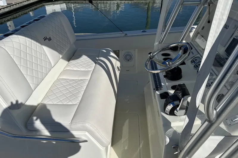 Showtime Yacht Photos Pics 2015 SeaVee 390Z boat interior with white seating and steering console.