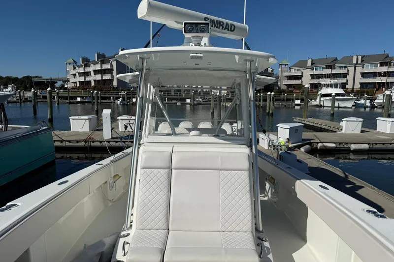 Showtime Yacht Photos Pics 2015 SeaVee 390Z boat docked at marina, featuring white seating and Simrad radar.