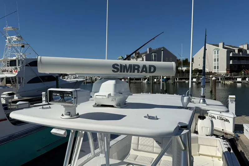 Showtime Yacht Photos Pics 2015 SeaVee 390Z boat with Simrad radar, docked in a marina under clear blue skies.