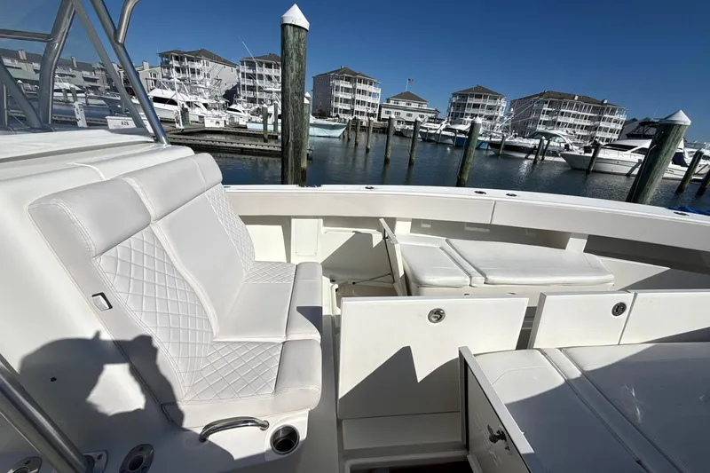 Showtime Yacht Photos Pics 2015 SeaVee 390Z boat interior with white seating, docked at marina.