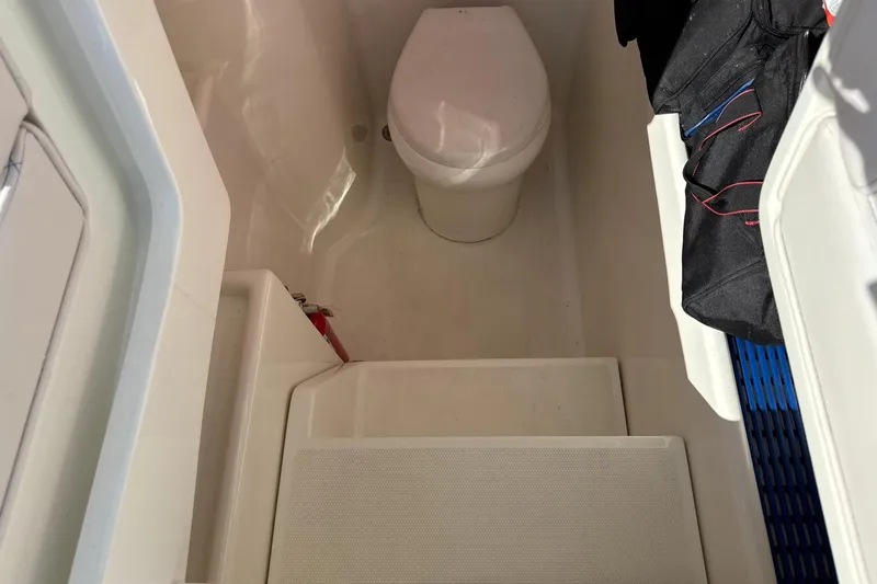 Showtime Yacht Photos Pics 2015 SeaVee 390Z boat interior with compact marine toilet and storage area.