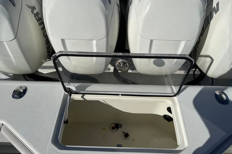 Showtime Yacht Photos Pics Open storage compartment on 2015 SeaVee 390Z boat with Mercury engines in background.