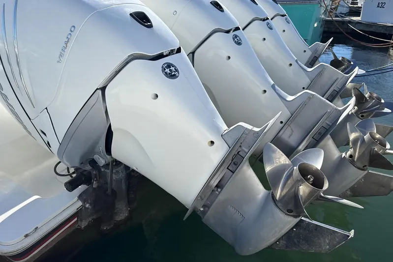 Showtime Yacht Photos Pics Triple outboard engines on a 2015 SeaVee 390Z boat, docked in a marina.