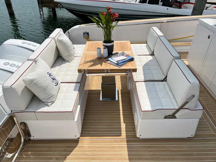  Yacht Photos Pics Luxurious seating area on 2023 Pardo Yachts 38 Outboard with elegant table and cushions.