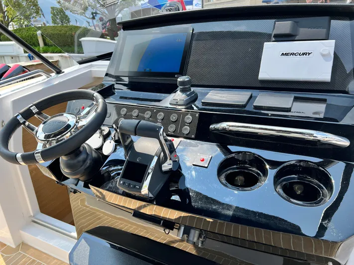  Yacht Photos Pics 2023 Pardo Yachts 38 Outboard helm with steering wheel, controls, and navigation display.