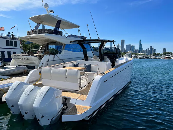  Yacht Photos Pics 2023 Pardo Yachts 38 Outboard docked with city skyline in background.