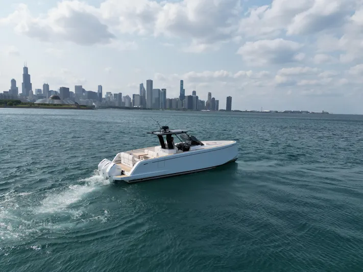  Yacht Photos Pics 2023 Pardo Yachts 38 Outboard cruising near city skyline on a sunny day.