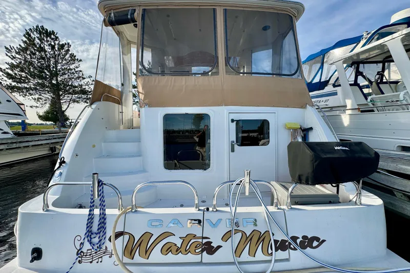 Water Music Yacht Photos Pics 2006 Carver 43 Motor Yacht docked, featuring "Water Music" name on the stern.