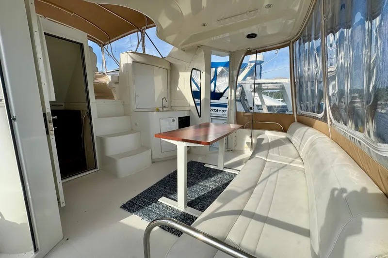 Water Music Yacht Photos Pics 2006 Carver 43 Motor Yacht interior with seating, table, and kitchenette.