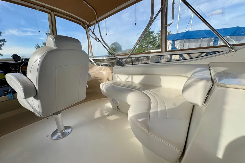 Water Music Yacht Photos Pics Interior of 2006 Carver 43 Motor Yacht with white seating and helm chair.
