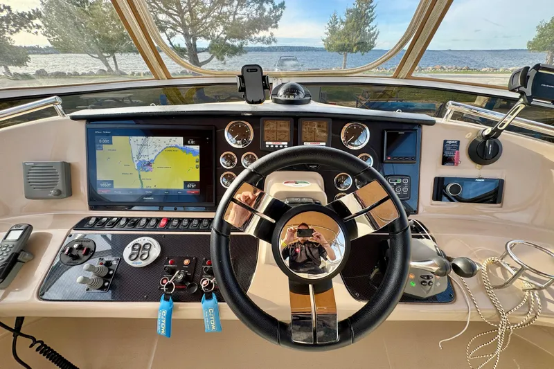 Water Music Yacht Photos Pics Helm of 2006 Carver 43 Motor Yacht with navigation screens and controls.