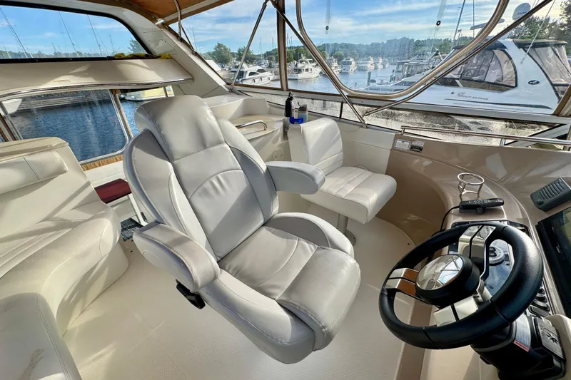 Water Music Yacht Photos Pics Captain's chair and helm of 2006 Carver 43 Motor Yacht, overlooking marina.