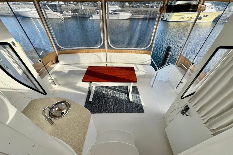Water Music Yacht Photos Pics Interior of 2006 Carver 43 Motor Yacht with seating and table, overlooking marina.