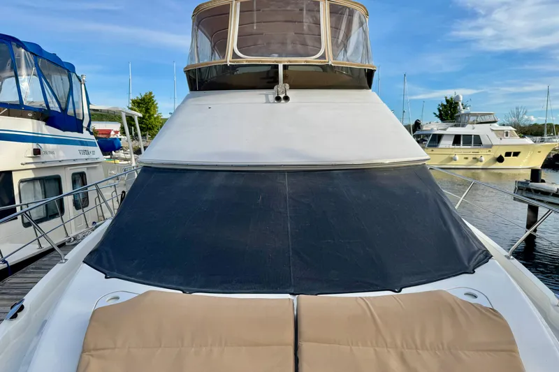 Water Music Yacht Photos Pics 2006 Carver 43 Motor Yacht docked at marina, featuring covered deck and clear sky.