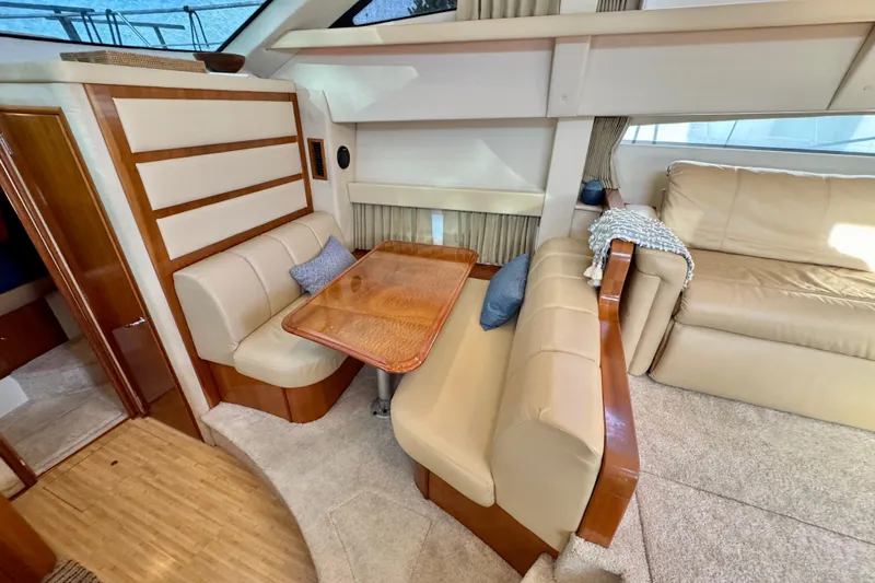 Water Music Yacht Photos Pics 2006 Carver 43 Motor Yacht interior with beige seating and wooden table.