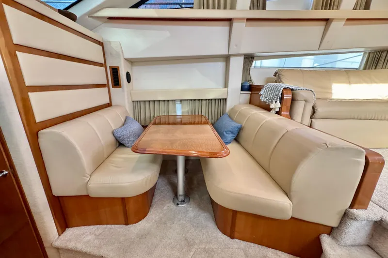Water Music Yacht Photos Pics 2006 Carver 43 Motor Yacht interior with beige seating and wooden table.
