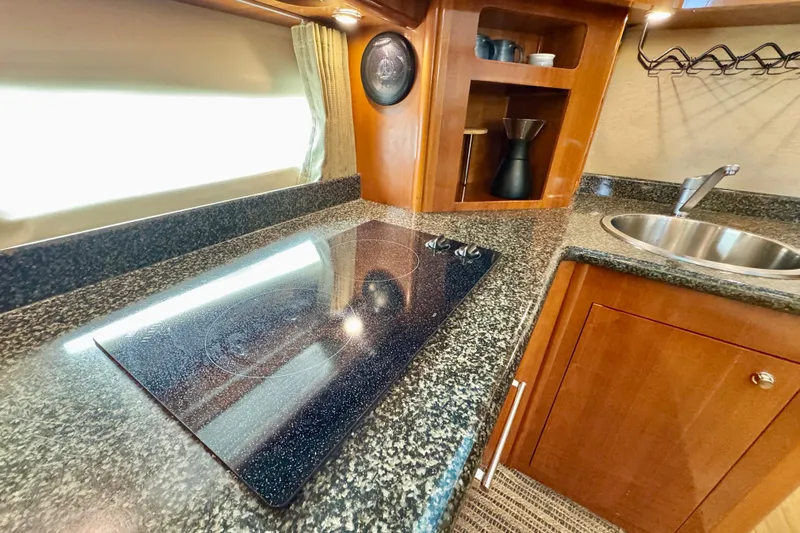 Water Music Yacht Photos Pics Luxurious 2006 Carver 43 Motor Yacht kitchen with sleek countertops and modern appliances.
