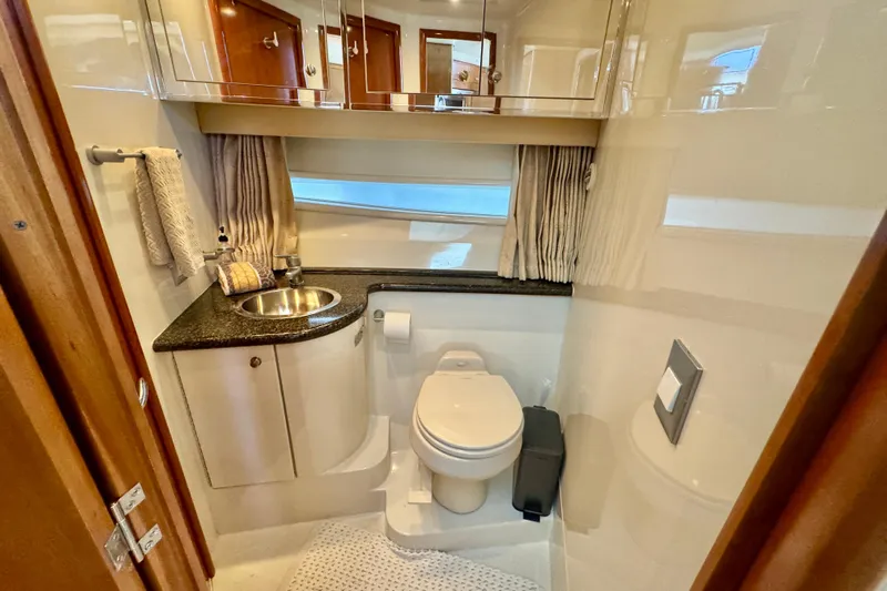 Water Music Yacht Photos Pics Bathroom interior of 2006 Carver 43 Motor Yacht with sink, toilet, and storage cabinets.