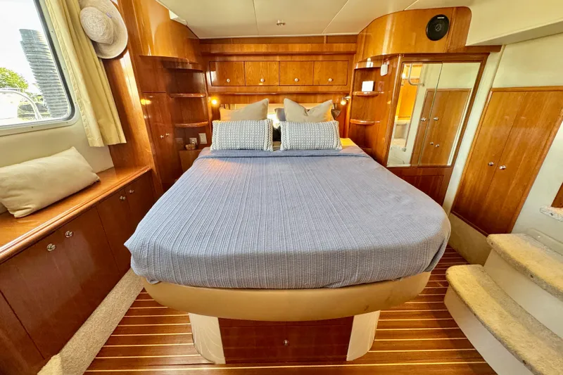 Water Music Yacht Photos Pics Luxurious 2006 Carver 43 Motor Yacht bedroom with elegant wood finishes and cozy bedding.