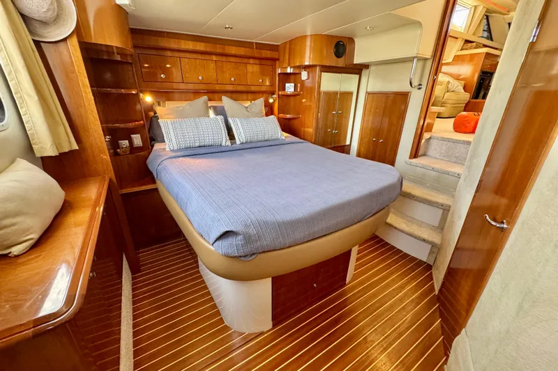 Water Music Yacht Photos Pics Luxurious 2006 Carver 43 Motor Yacht bedroom with elegant wood finishes and cozy bedding.