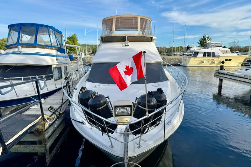 Water Music Yacht Photos Pics 2006 Carver 43 Motor Yacht with Canadian flag docked at marina.