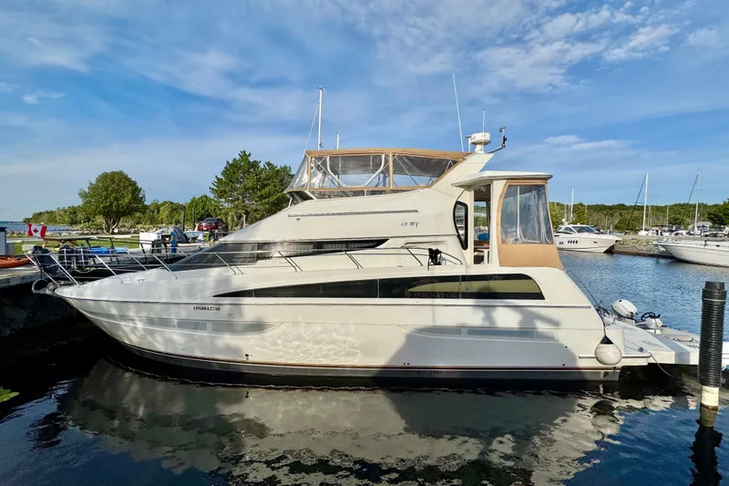 Water Music Yacht Photos Pics 2006 Carver 43 Motor Yacht docked at a marina under a clear blue sky.
