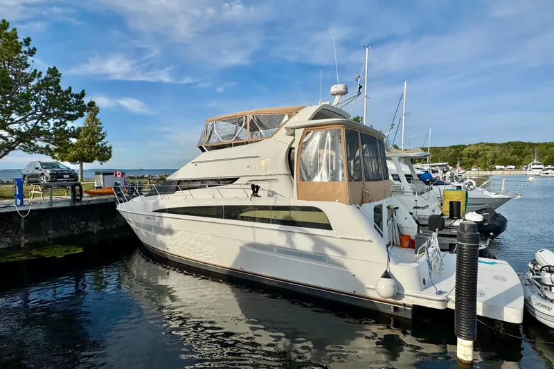 Water Music Yacht Photos Pics 2006 Carver 43 Motor Yacht docked at a marina under a clear blue sky.