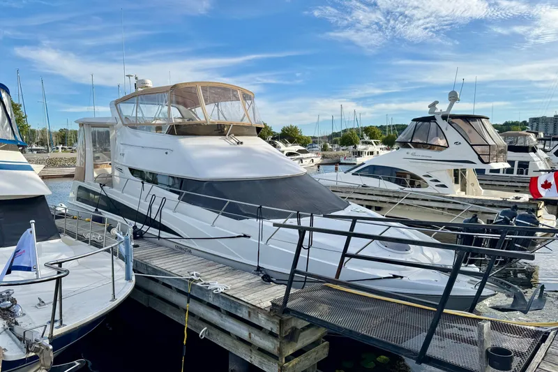 Water Music Yacht Photos Pics 2006 Carver 43 Motor Yacht docked at a marina, surrounded by other boats.