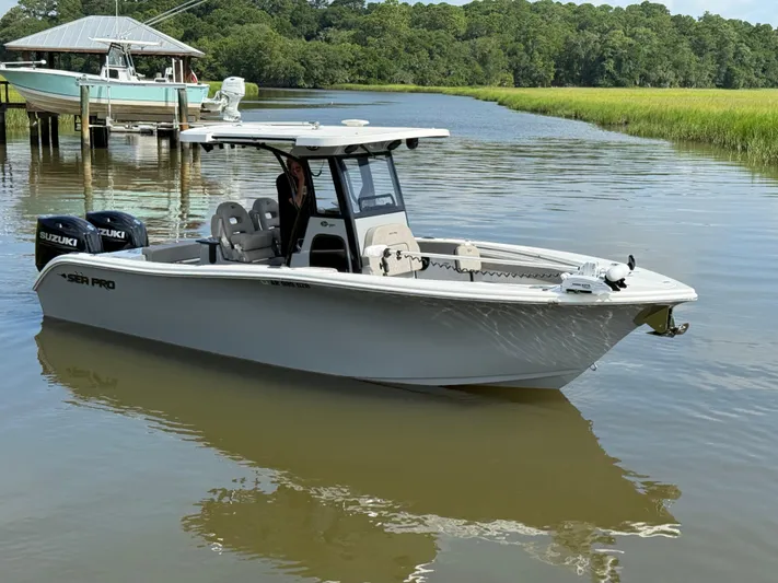  Yacht Photos Pics 2024 Sea Pro 262DLX boat on calm water, featuring dual Suzuki engines.
