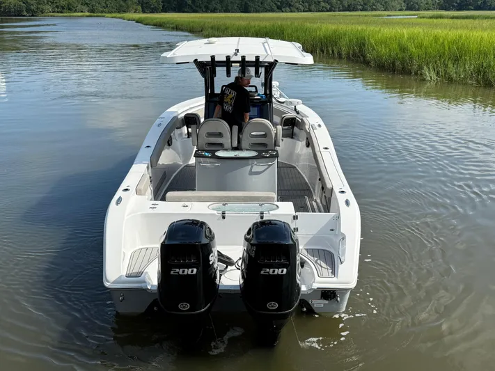 Yacht Photos Pics 2024 Sea Pro 262DLX boat with dual engines on a calm waterway.