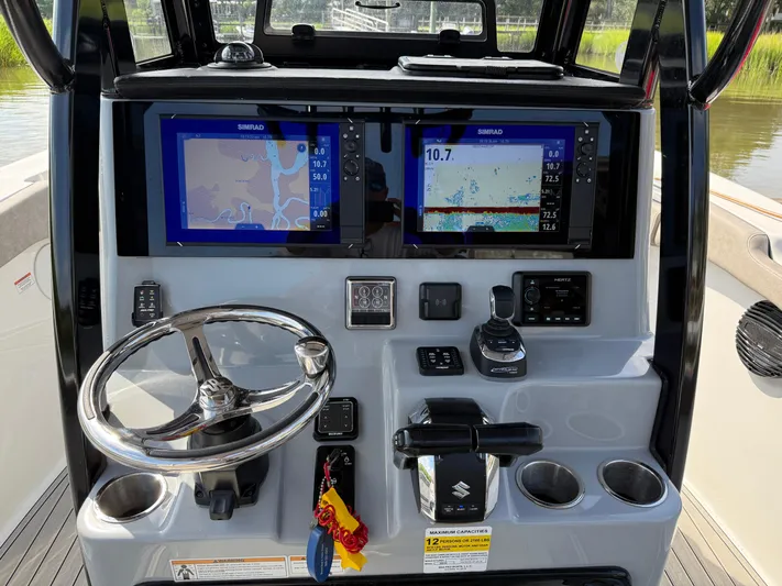  Yacht Photos Pics 2024 Sea Pro 262DLX boat dashboard with dual Simrad displays and steering wheel.