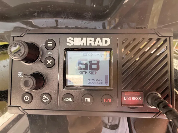  Yacht Photos Pics Simrad marine radio on 2024 Sea Pro 262DLX, displaying channel 68 and distress button.