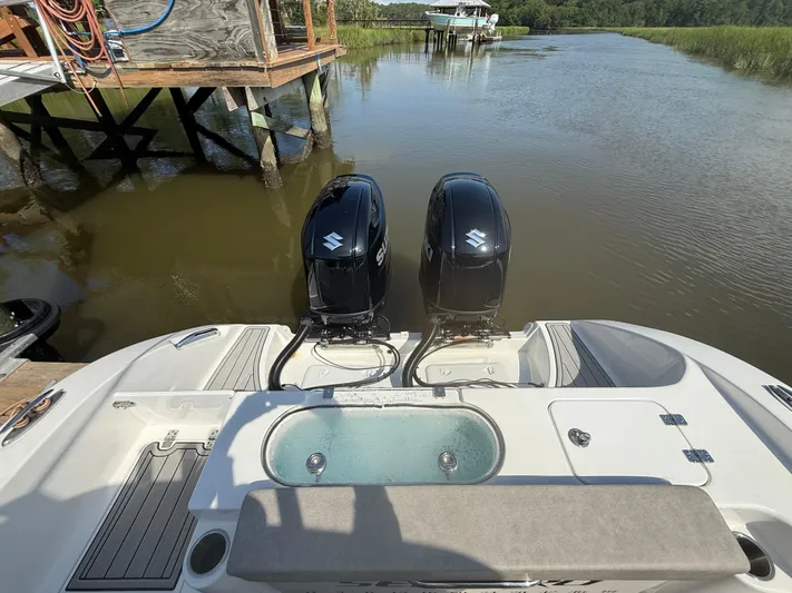  Yacht Photos Pics 2024 Sea Pro 262DLX boat with dual Suzuki outboard motors on a calm river.