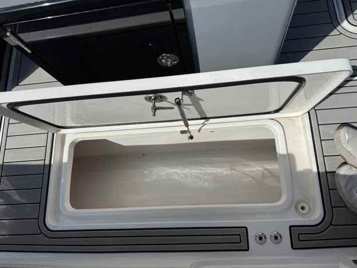  Yacht Photos Pics Open storage compartment on 2024 Sea Pro 262DLX boat deck.