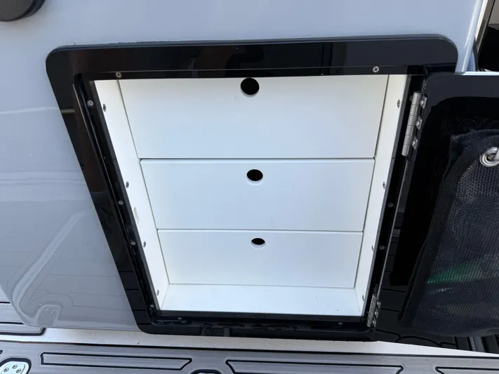  Yacht Photos Pics 2024 Sea Pro 262DLX boat storage compartment with three white drawers.