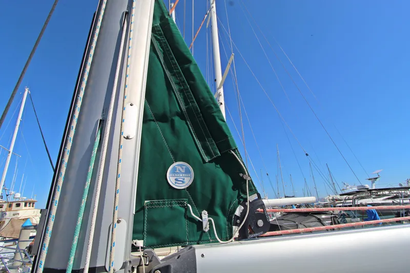  Yacht Photos Pics 2001 Beneteau Oceanis 461 sailboat mast with green sail cover, clear blue sky.
