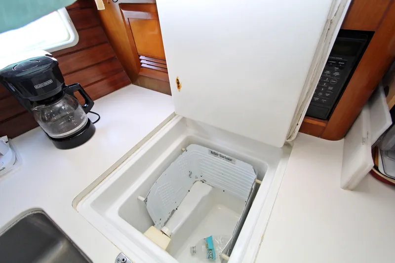  Yacht Photos Pics 2001 Beneteau Oceanis 461 yacht galley with open fridge and coffee maker.