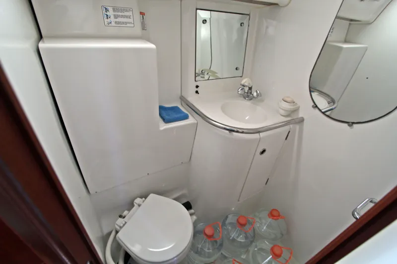  Yacht Photos Pics Bathroom of 2001 Beneteau Oceanis 461 yacht with sink, toilet, and storage.