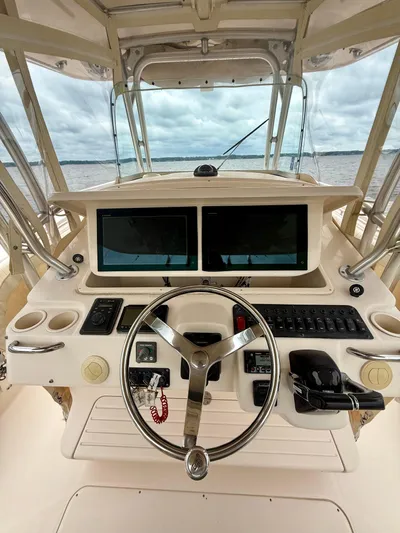  Yacht Photos Pics 2008 Grady-White Canyon 336 helm with dual screens and steering wheel, overlooking water.