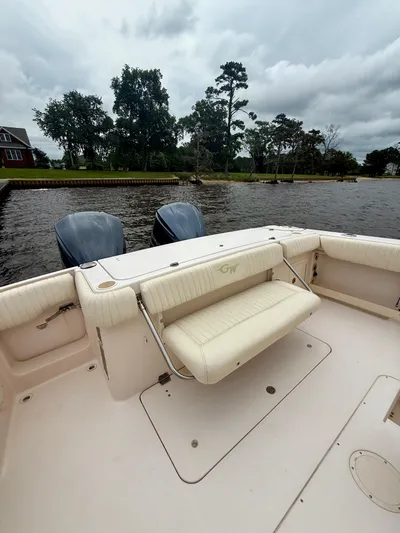  Yacht Photos Pics 2008 Grady-White Canyon 336 boat with dual engines, docked by a scenic waterfront.