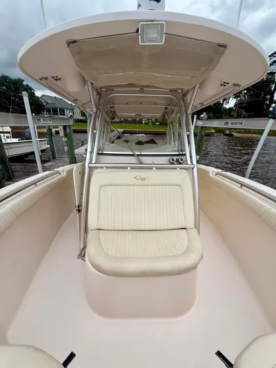  Yacht Photos Pics 2008 Grady-White Canyon 336 boat interior with seating and helm, docked by the water.