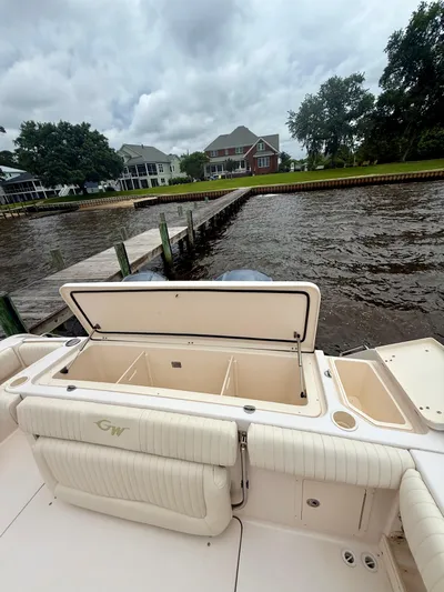  Yacht Photos Pics 2008 Grady-White Canyon 336 boat docked by waterfront homes under cloudy skies.