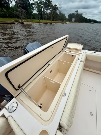  Yacht Photos Pics 2008 Grady-White Canyon 336 boat with open storage compartment by the water.