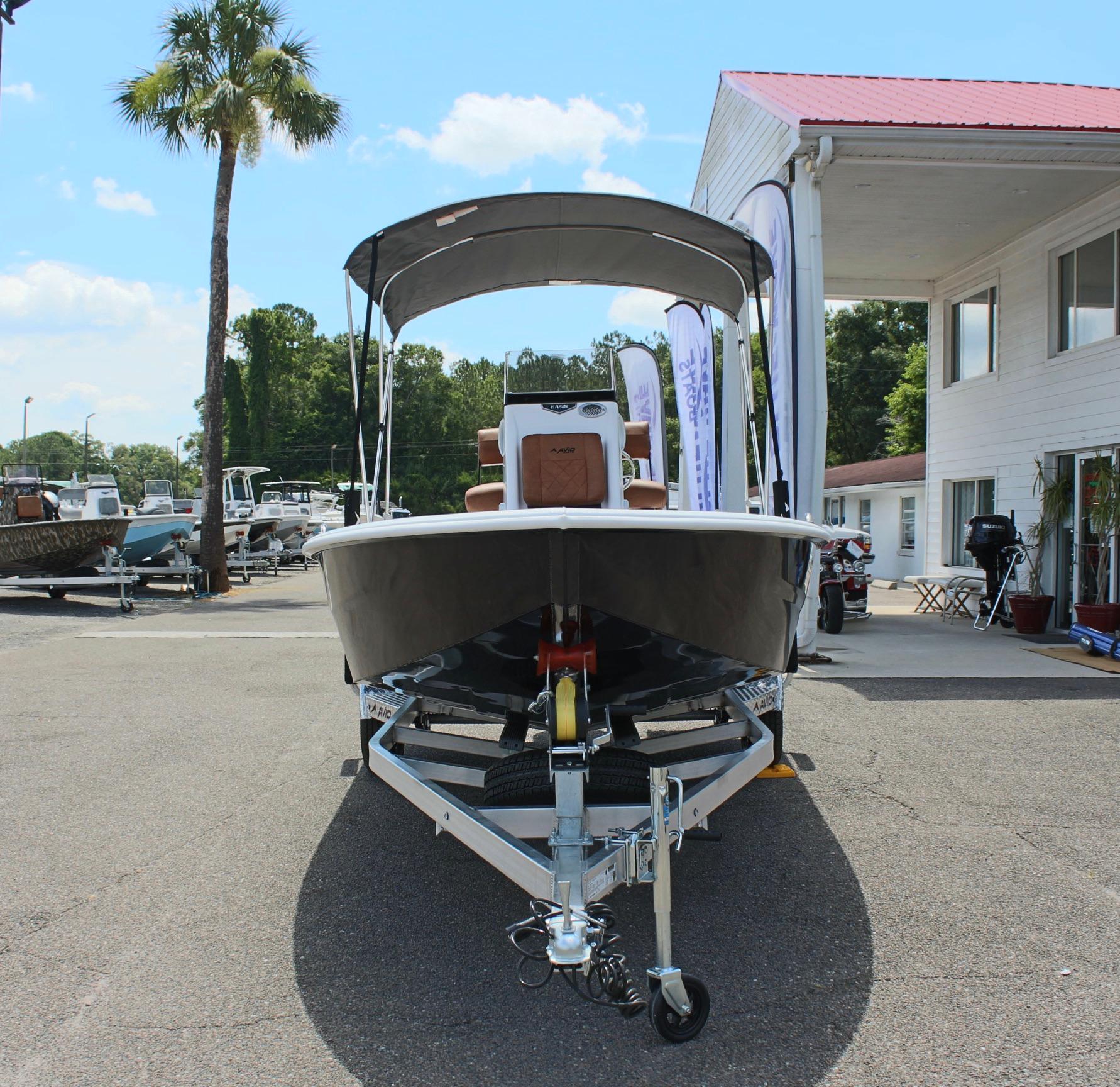 2024 Avid 21 Fusion boat on trailer at dealership.