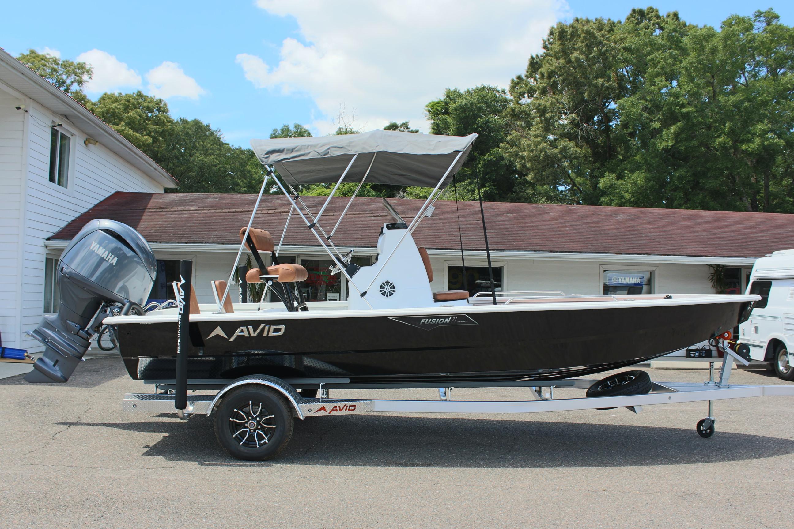 2024 Avid 21 Fusion boat on trailer with canopy and outboard motor.