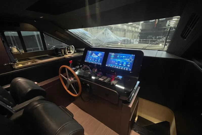  Yacht Photos Pics 2024 Cranchi 67 Sessantasette Fly yacht cockpit with modern navigation displays and steering wheel.