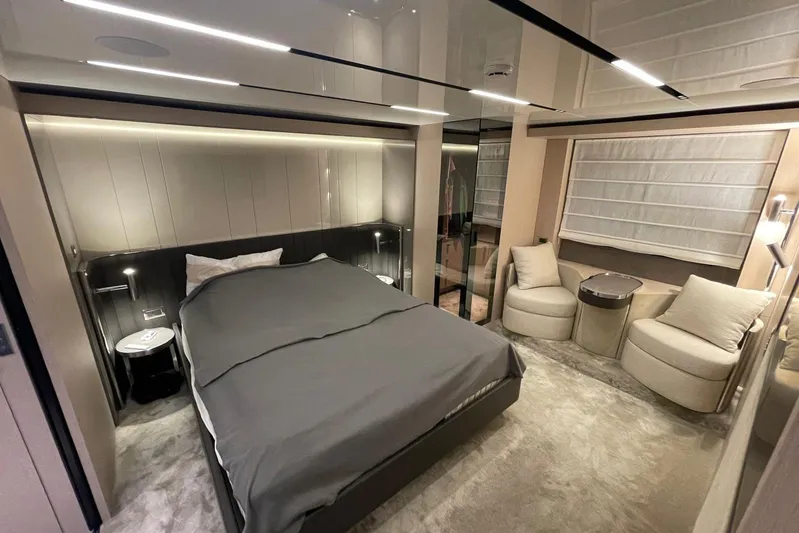  Yacht Photos Pics Luxurious bedroom interior of 2024 Cranchi 67 Sessantasette Fly yacht, featuring modern design and elegant furnishings.