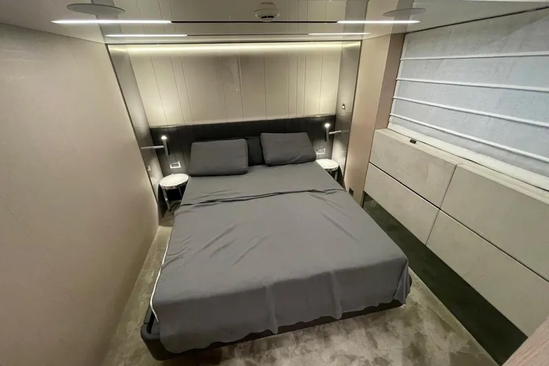  Yacht Photos Pics Luxurious bedroom interior of 2024 Cranchi 67 Sessantasette Fly yacht, featuring modern design and elegant furnishings.