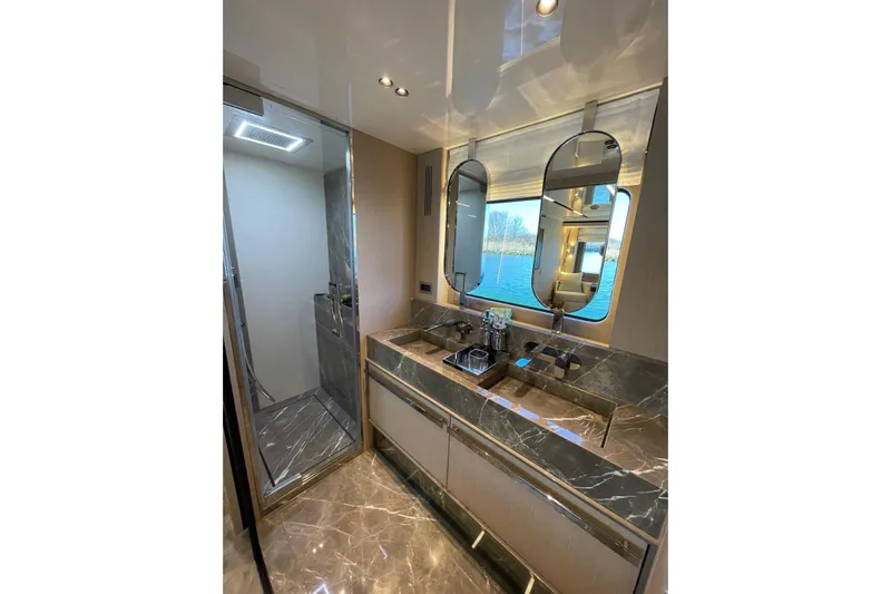 Yacht Photos Pics Luxurious bathroom in 2024 Cranchi 67 Sessantasette Fly yacht with marble finishes and modern fixtures.