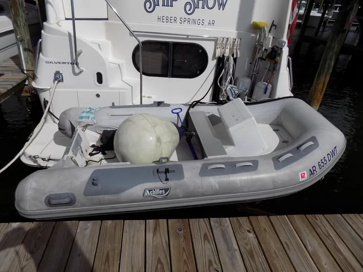  Yacht Photos Pics 2005 Silverton 43 Motor Yacht docked with inflatable dinghy attached.